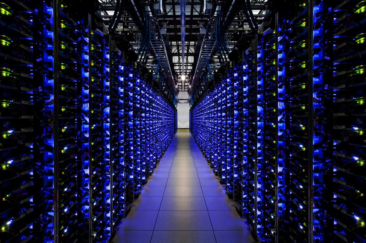A central aisle between rows of illuminated server racks